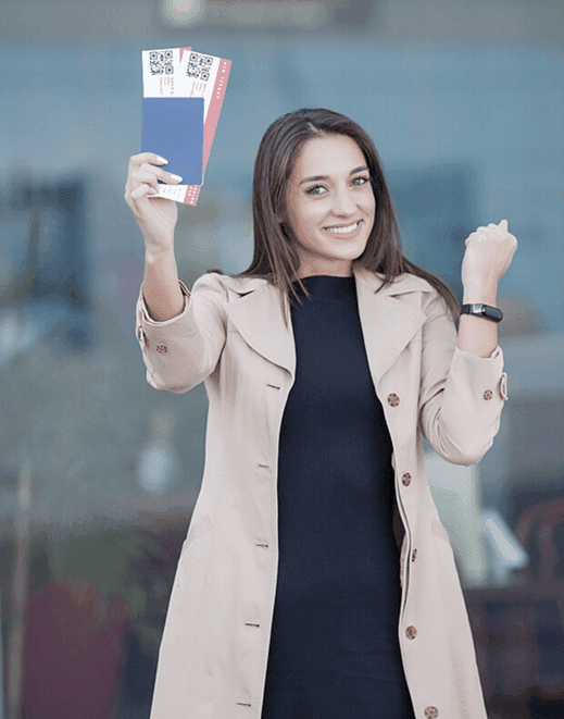 Student celebrating with travel tickets